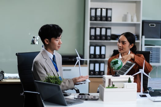 Asian businesswoman and man discussing business in office photo
