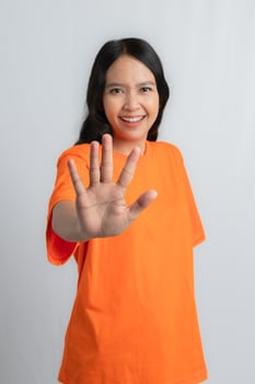 A woman holding up her hand showing a stop sign photo