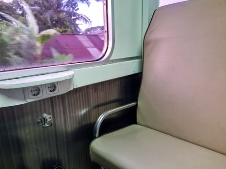 Empty Train Seat with Power Outlet and Cup Holder photo