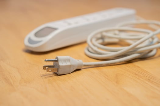 4 outlets portable power extension board on wooden background. photo