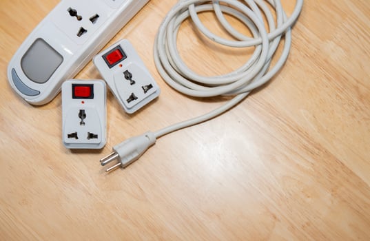 White power extension lead with multiple sockets on wooden table. photo