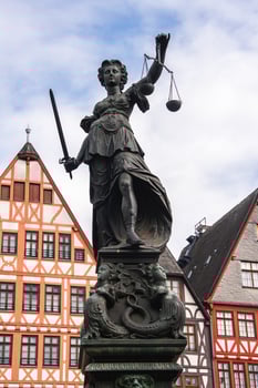 A statue of a lady holding a sword and scales photo