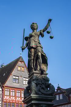 A statue of a lady holding a scale of justice photo