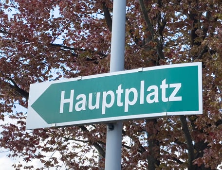 Green hauptplatz sign with autumn leaves in the background photo