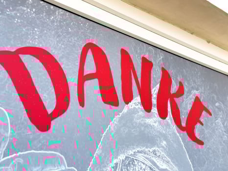 Danke sign in red letters on textured background photo