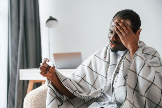 Horrible ,headache. Sick black man is, at home photo