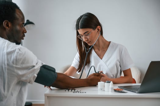Healthcare conception.. Female,, doctor measures blood pressure of a man photo
