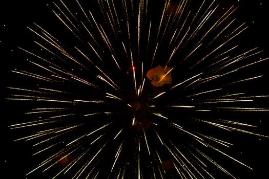 Spectacular golden fireworks show in night sky, shining sparks and trails perfect for celebration backgrounds photo
