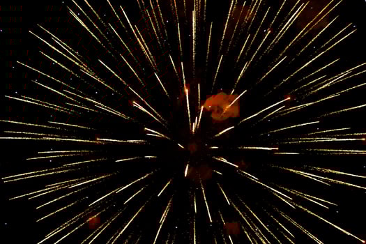 Spectacular golden fireworks show in night sky, shining sparks and trails perfect for celebration photo