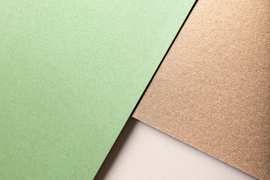 Paper background with matte texture. Layered diagonal sheets in pastel green, mint green, champagne, photo