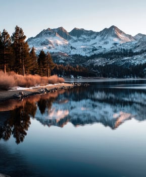 A lake with snow capped mountains in the background photo