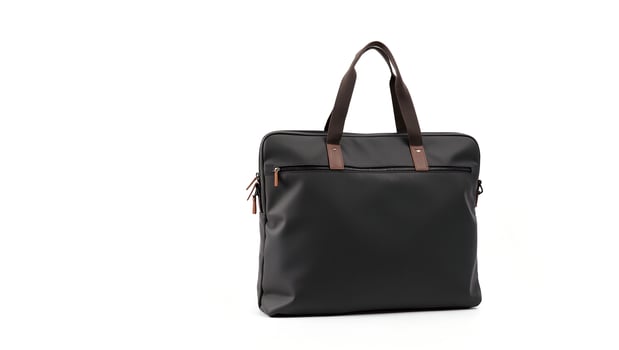 A black leather tote bag with brown handles photo