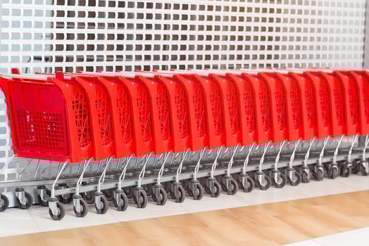 Red shopping carts in a row in the market photo