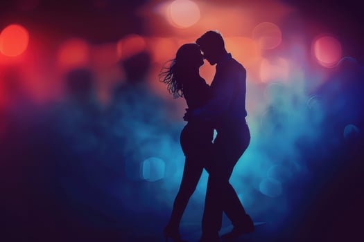 Silhouette of the man and woman dancing on a dance floor. Dark background with pink and purple colors. photo
