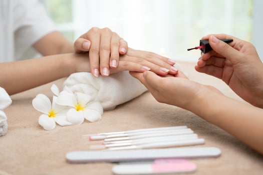 Woman receive care service by professional Beautician Manicure at spa centre. Nail beauty salon use nail file for Glazing treatment. manicurist make nail customer to beautiful body care spa treatment photo