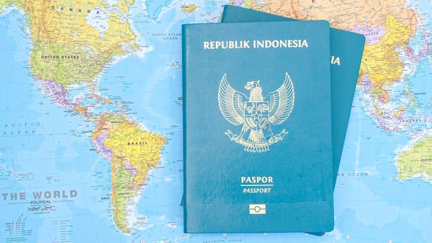 Yogyakarta, Indonesia, 2025 - Indonesian passports on world map background photo
