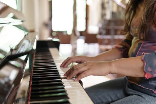 Girl learn to play piano. woman hand playing piano photo