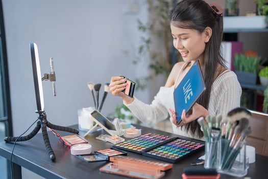 Beauty influencer Asian girl Using Social Media for live streaming on Smartphone online audience like and subscribe to her channel. photo