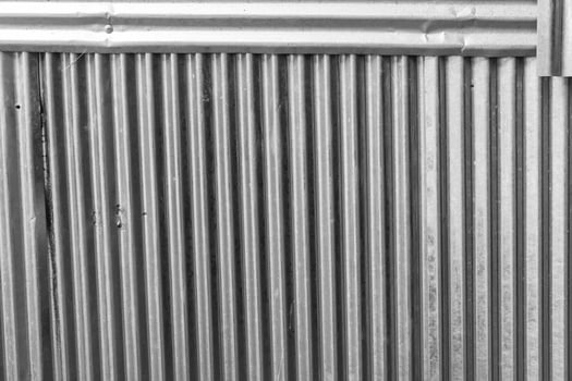 a black and white photo of a metal wall