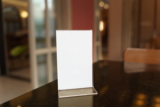 Mock up Menu frame standing on wood table in restaurant photo