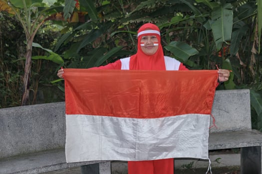Woman holding national flag for independence celebration and patriotic event photo