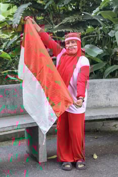 Independence Day spirit with national flag waving by cheerful woman photo