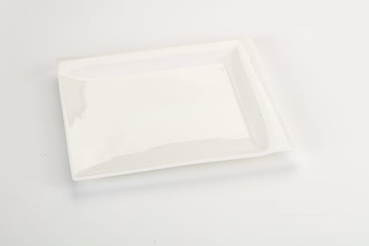 A white square plate with a white lid photo