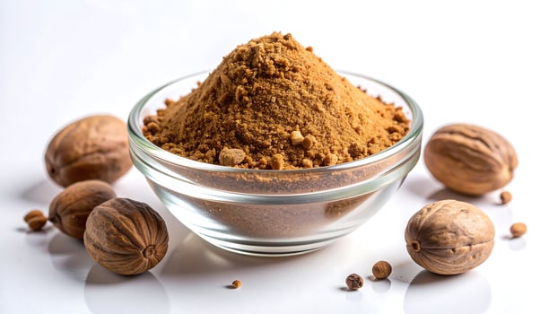 Nutmeg Powder in Bowl with Whole Nutmeg photo