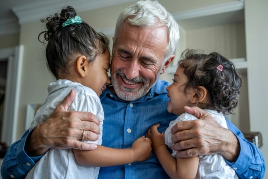 Grandfather shares heartfelt moments with his granddaughters in a cozy living room, capturing love and joy during an afternoon gathering photo