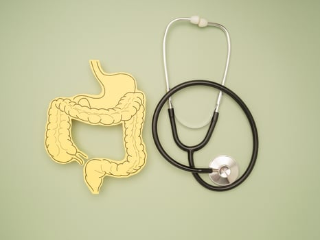 Top view of a stethoscope and intestine symbol made on a green background photo