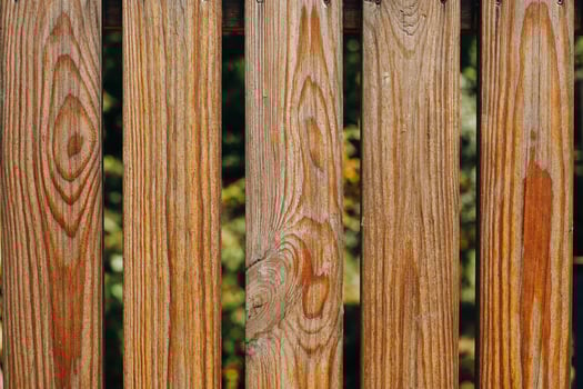 Natural wooden fence planks creating an organic look in a garden setting photo