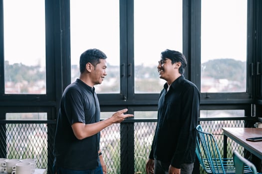 Two happy men having a casual conversation in a cozy indoor space photo