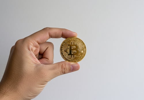 Bitcoin Coin on Wooden Surface with Bokeh Lights photo