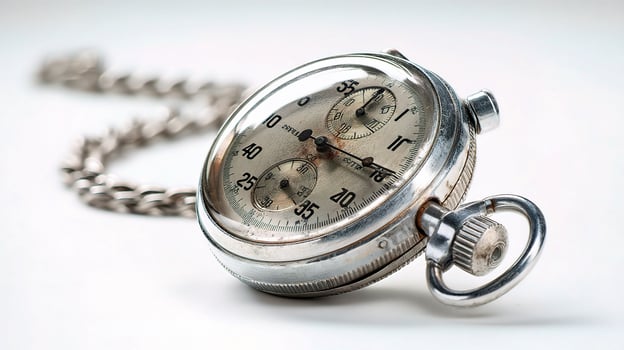 An old pocket watch with chain attached to it photo