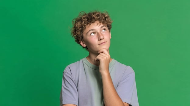 A boy with curly hair looking up at something photo