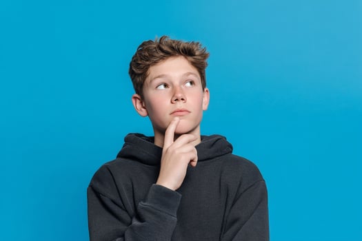 A young boy is looking up at something photo