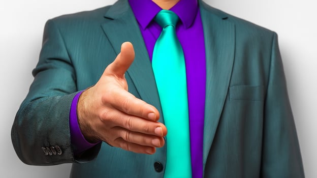 A man in a suit and purple tie is giving a thumbs up photo