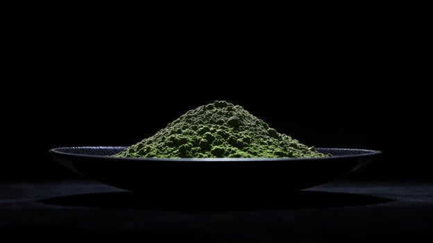 Mound of bright green matcha powder in black bowl against dark background photo