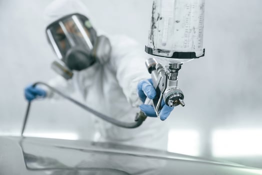 Close, up, view of man that is painting a car by using spray guy photo