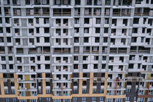 A large building with many windows and a lot of scaffolding photo