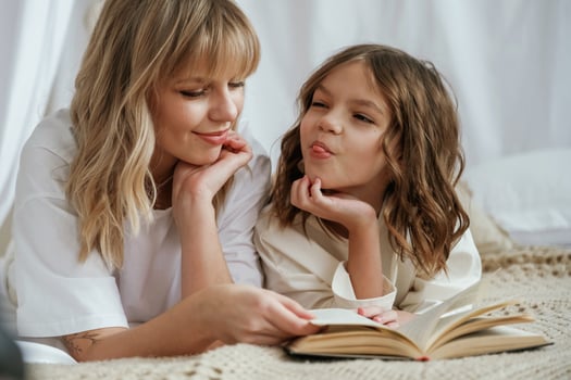 Reading, the book together. Mother with daughter are at home photo