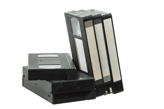 Leaning Stack of Old VHS Cassettes on White Background photo
