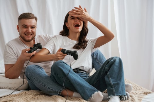 Playing game with joysticks. .Young couple are together at home photo