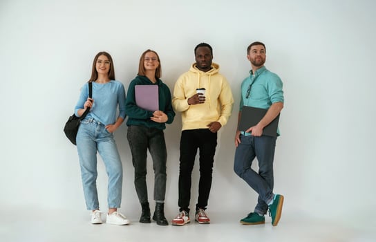 Looking, forward. Group ,of young ,people are standing against white background photo