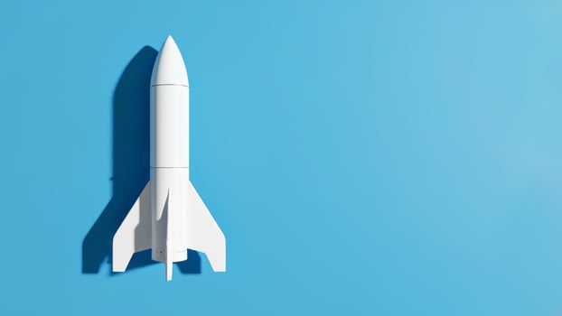 Minimalist white rocket model casting shadow on bright blue background photo