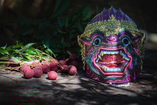 Khon is a rare Thai cultural performance. The image shows a purple monkey's head and fruit. photo
