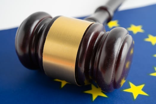 EU flag Legal, justice and agreement, wooden court gavel on flag. photo