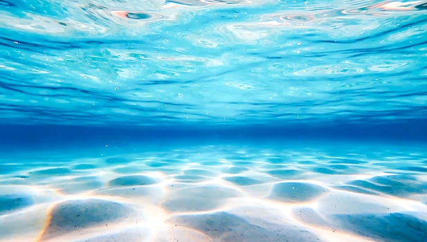 Crystal-clear underwater background with sunlight photo