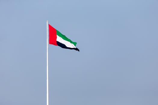 UAE Flag in Abu Dhabi Waving Outside. UAE National Day. Flag Day. photo