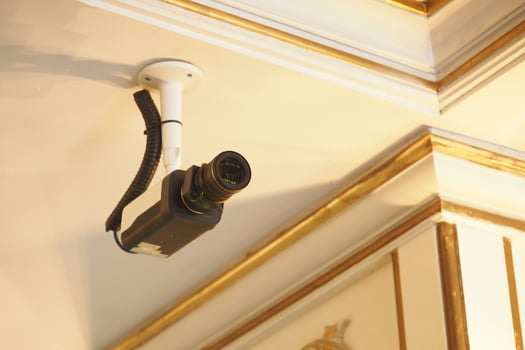 Surveillance camera installed on ceiling in a decorated interior photo